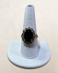 Vintage Avon Silver-tone Ring Featuring a Large Oval Black Stone Surrounded by 14 smaller White Rhinestones Estate Sale (Great Condition)