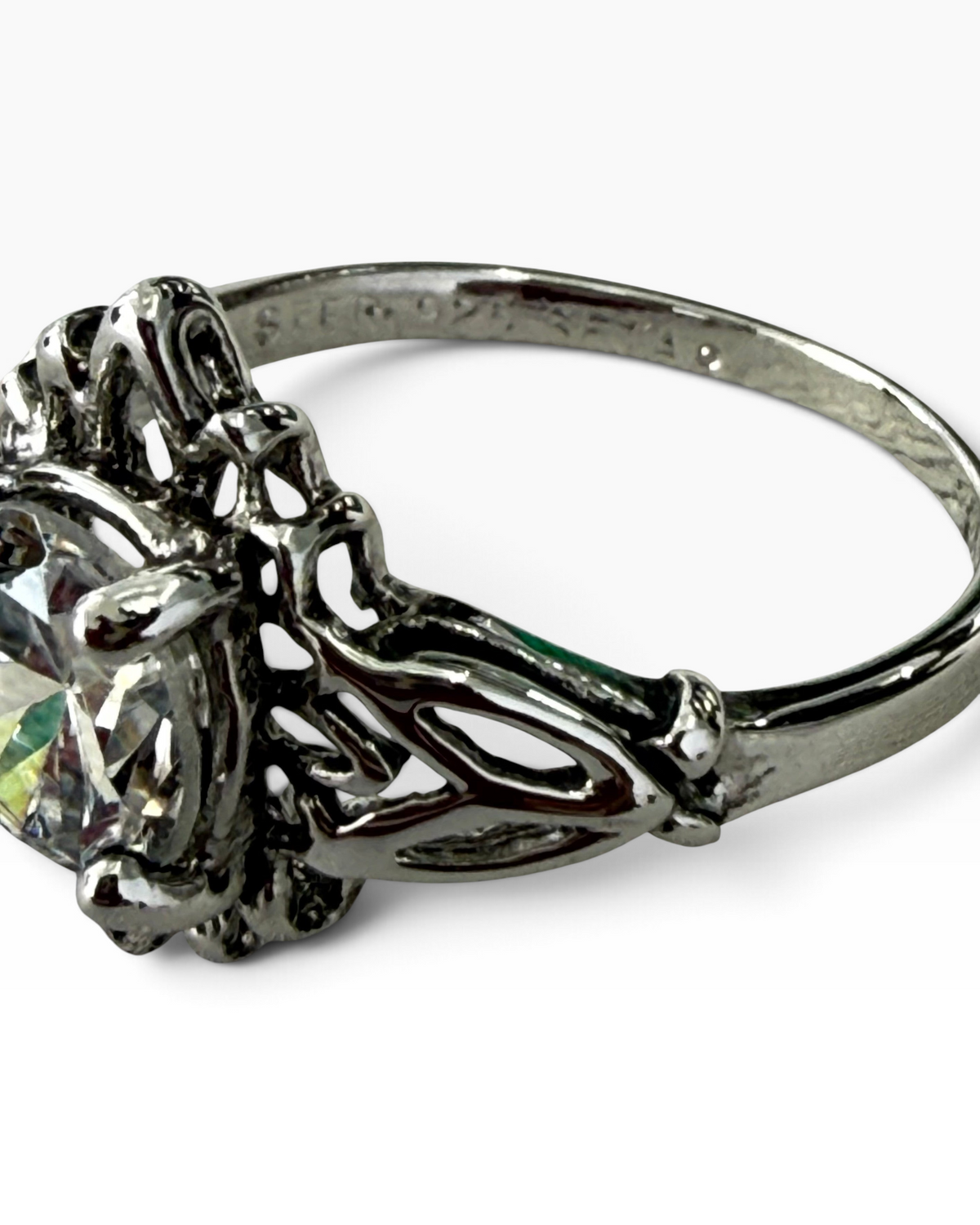 Cavallaro Creations sterling silver ring with a round-cut clear stone and intricate vintage filigree band detail.