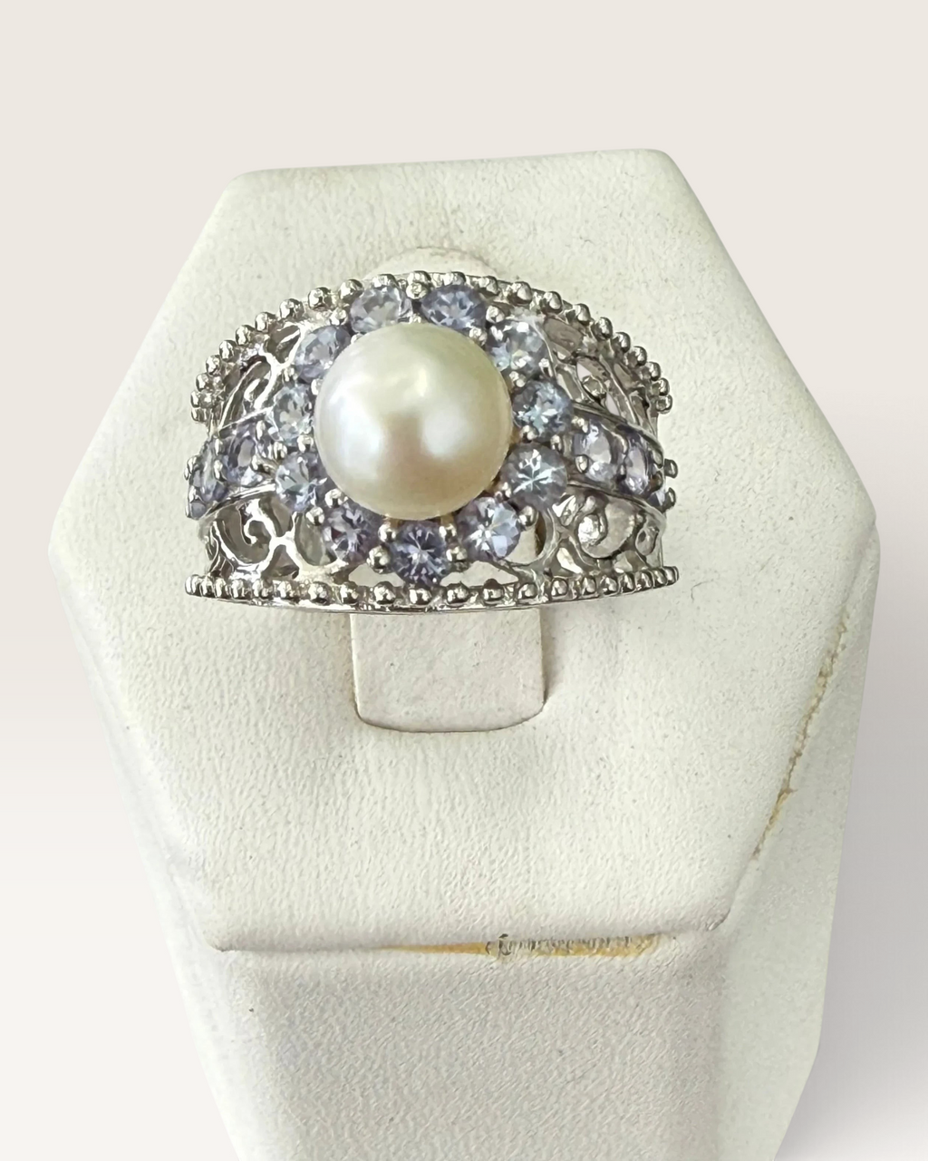 Cavallaro Creations sterling silver ring with a central pearl, halo of accent stones, and intricate filigree band.