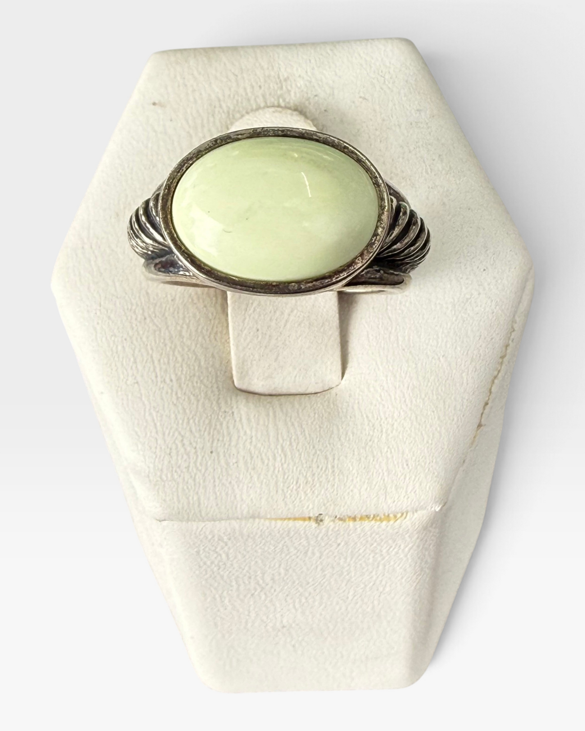 Cavallaro Creations sterling silver ring with a pale green oval cabochon stone and textured ribbed band details.