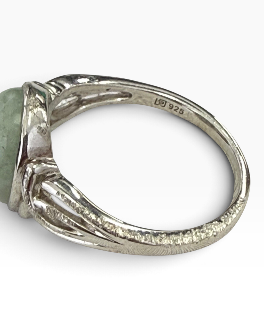 Cavallaro Creations sterling silver ring with oval pale green cabochon and intricate scrollwork on the band