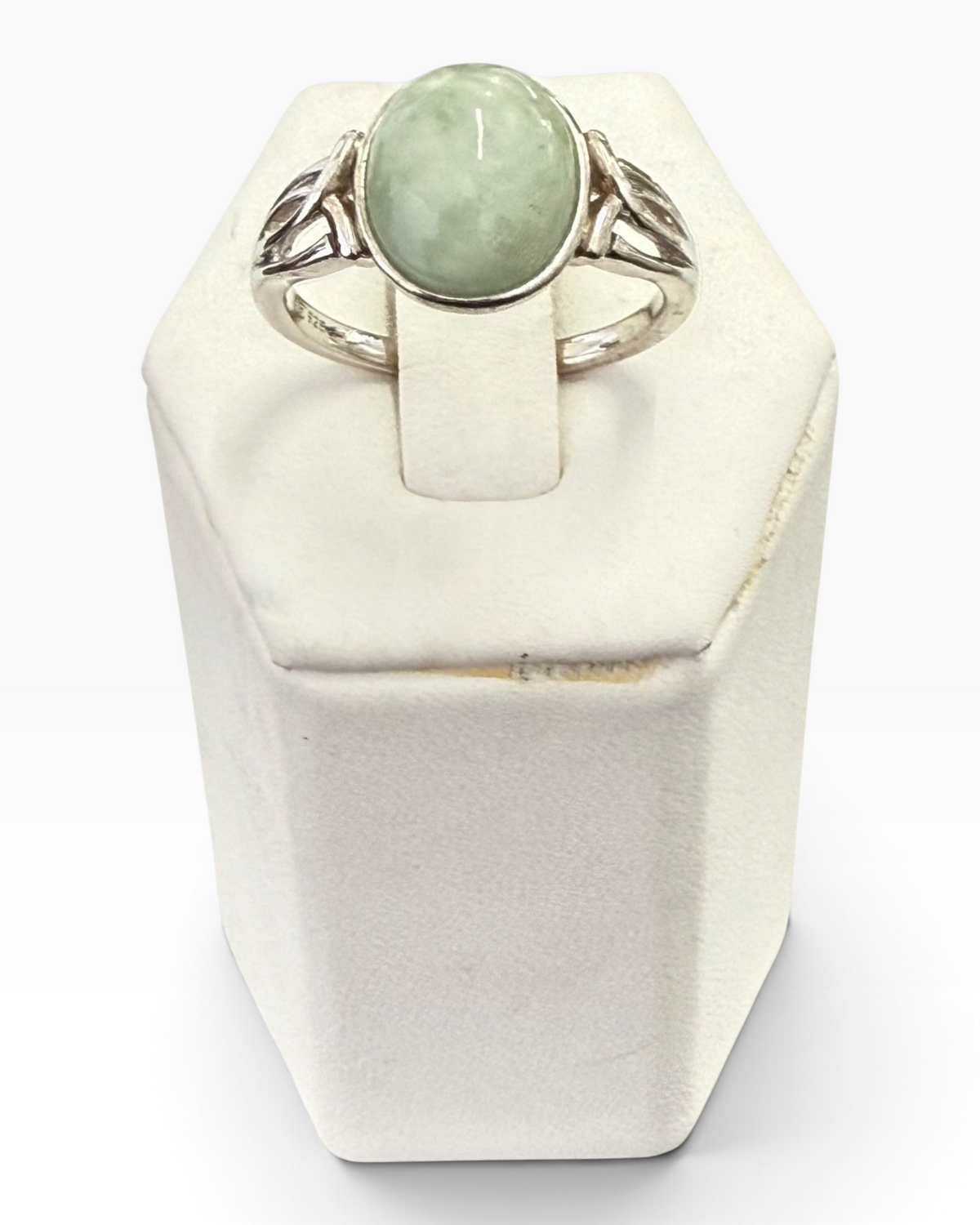 Cavallaro Creations sterling silver ring featuring a pale green oval cabochon gemstone and intricate scrollwork band.