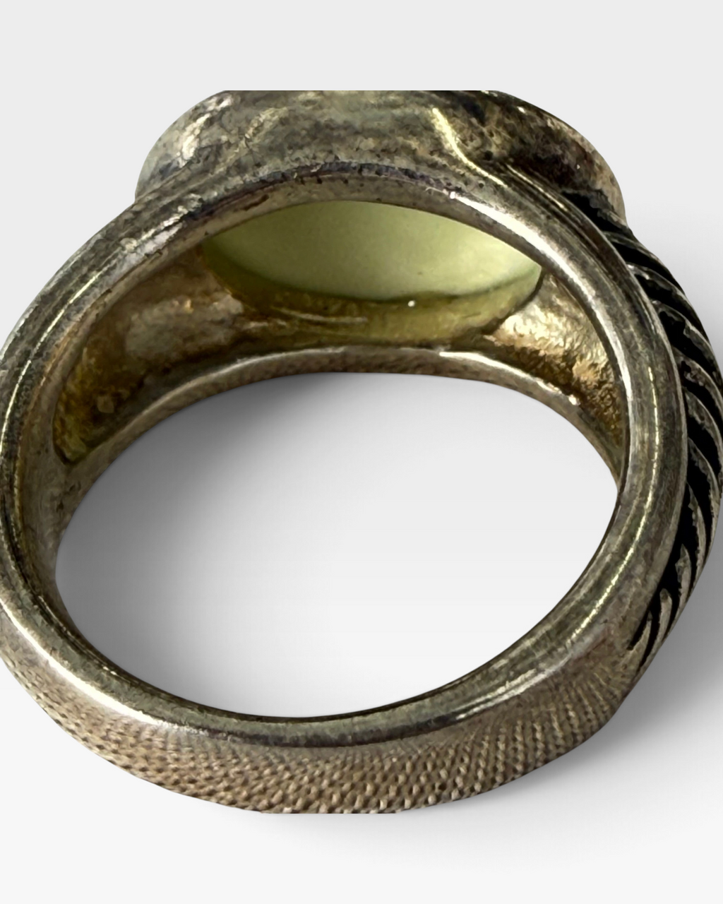Cavallaro Creations sterling silver ring with a pale green oval cabochon and textured ribbed band details.