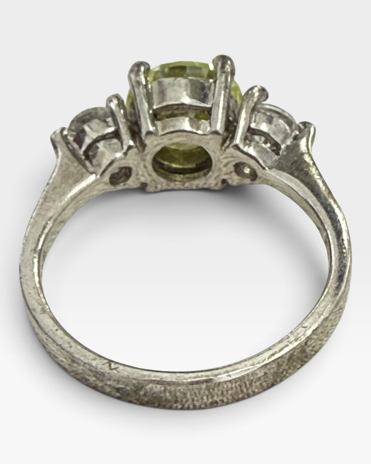Cavallaro Creations three-stone ring with a yellow center stone and clear side stones on a polished silver-tone band.