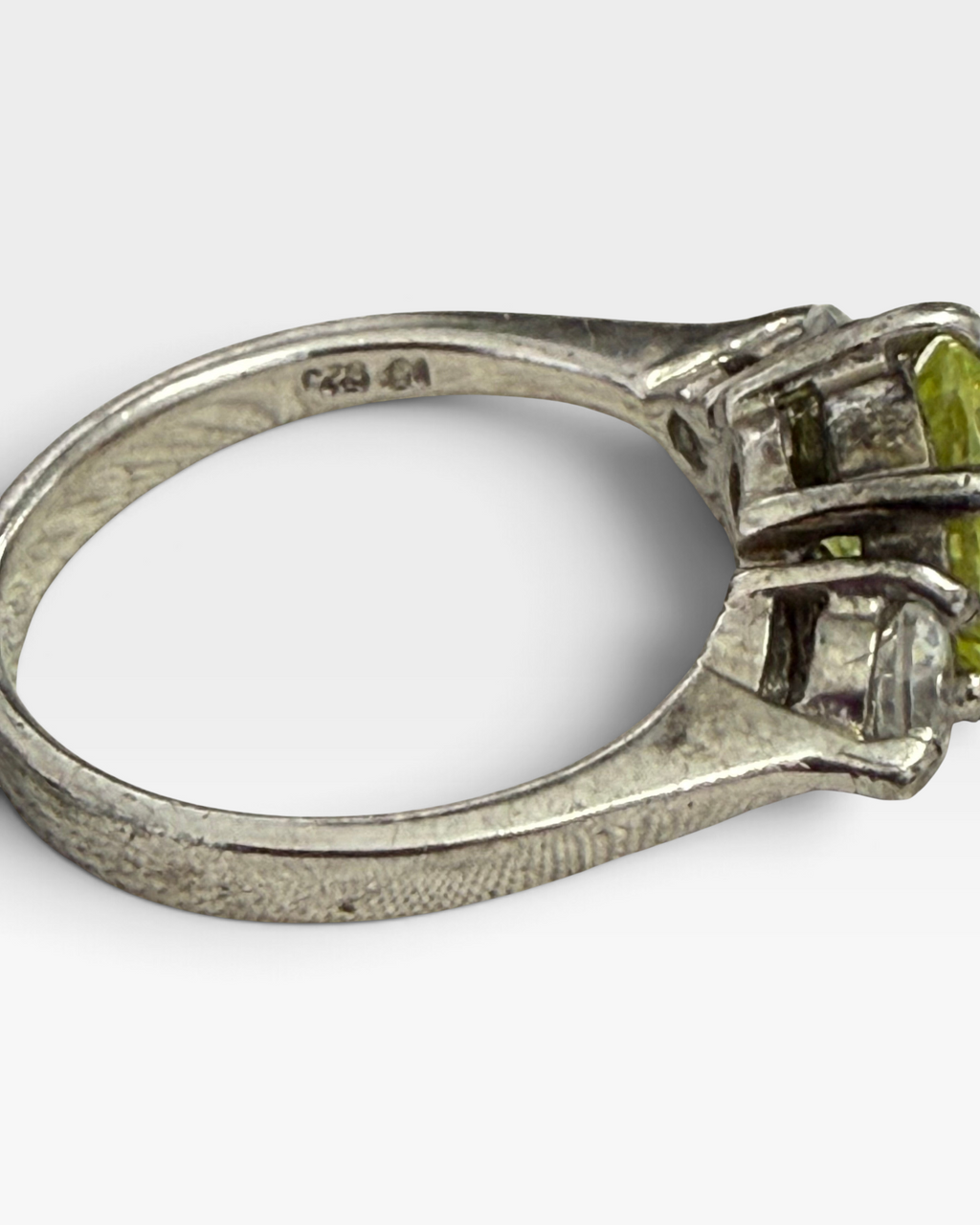 Cavallaro Creations three-stone ring with a yellow center stone and clear side stones on a polished silver-tone band.