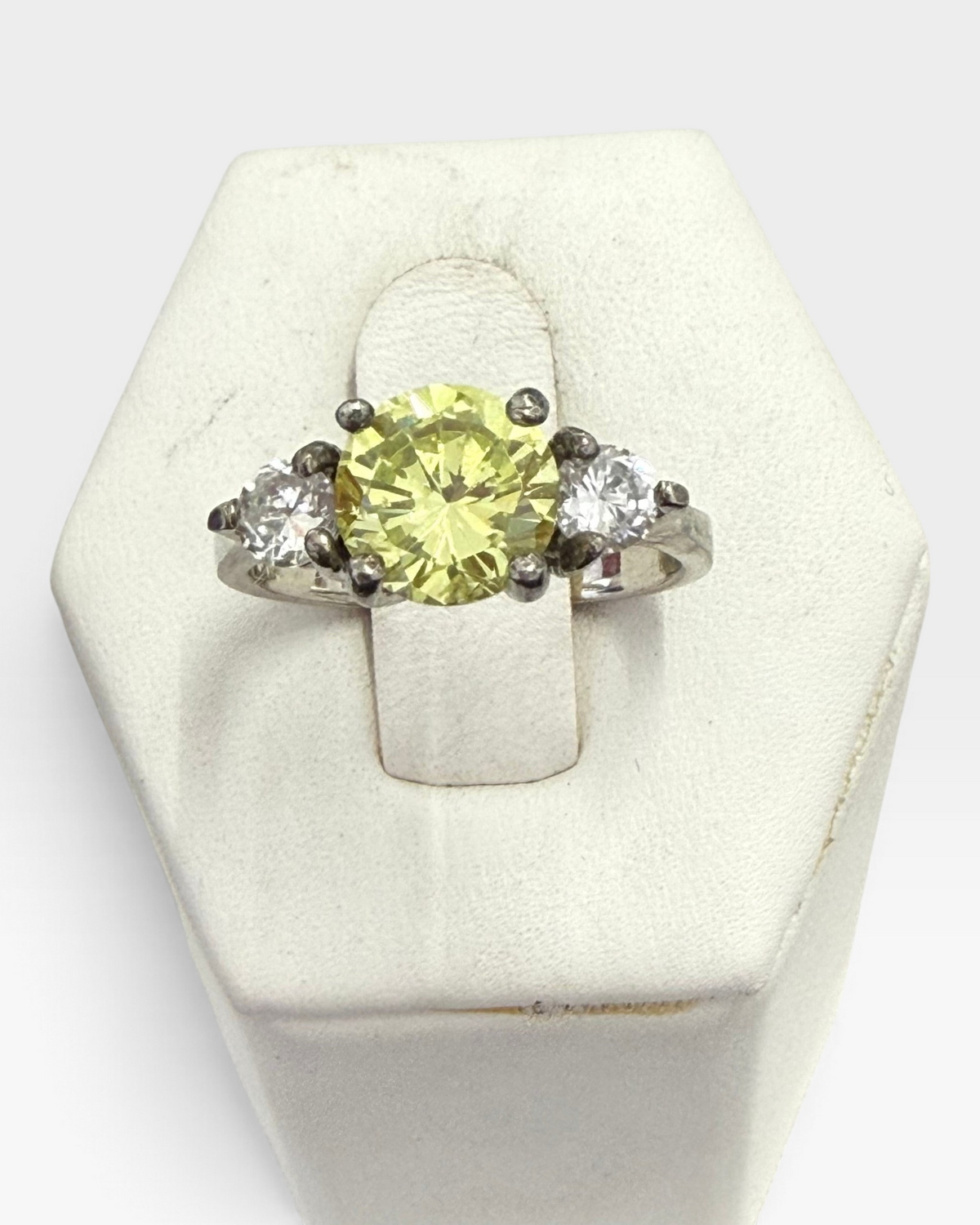 Cavallaro Creations three-stone ring with a large yellow center stone and two clear side stones on a silver band.