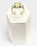 Cavallaro Creations three-stone ring with a yellow center stone and clear side stones on a polished silver-tone band.