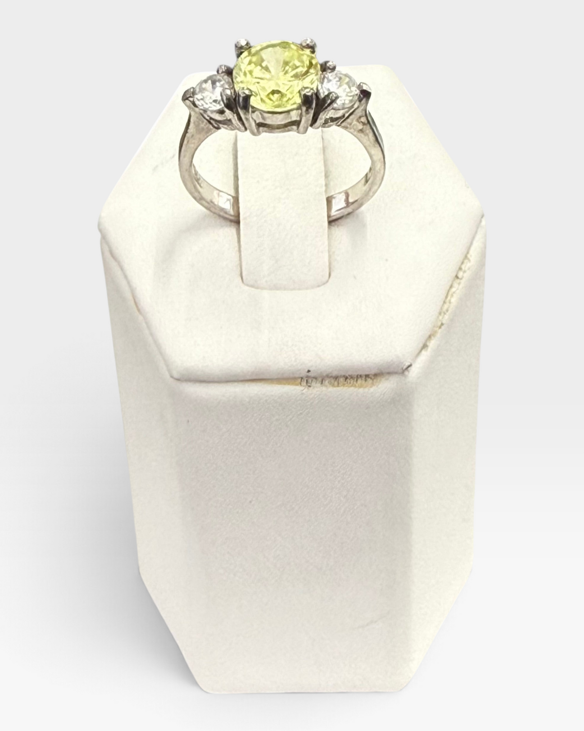 Cavallaro Creations three-stone ring with a yellow center stone and clear side stones on a polished silver-tone band.